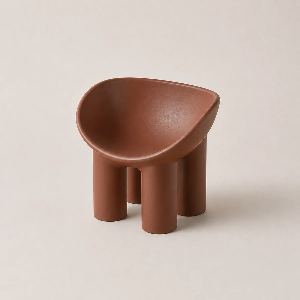 A small sculptural PE stool in a warm terracotta brown color, featuring a rounded, bowl-like seat supported by four cylindrical legs, set against a solid light beige background.