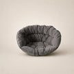 Dark gray pet bed on a beige background