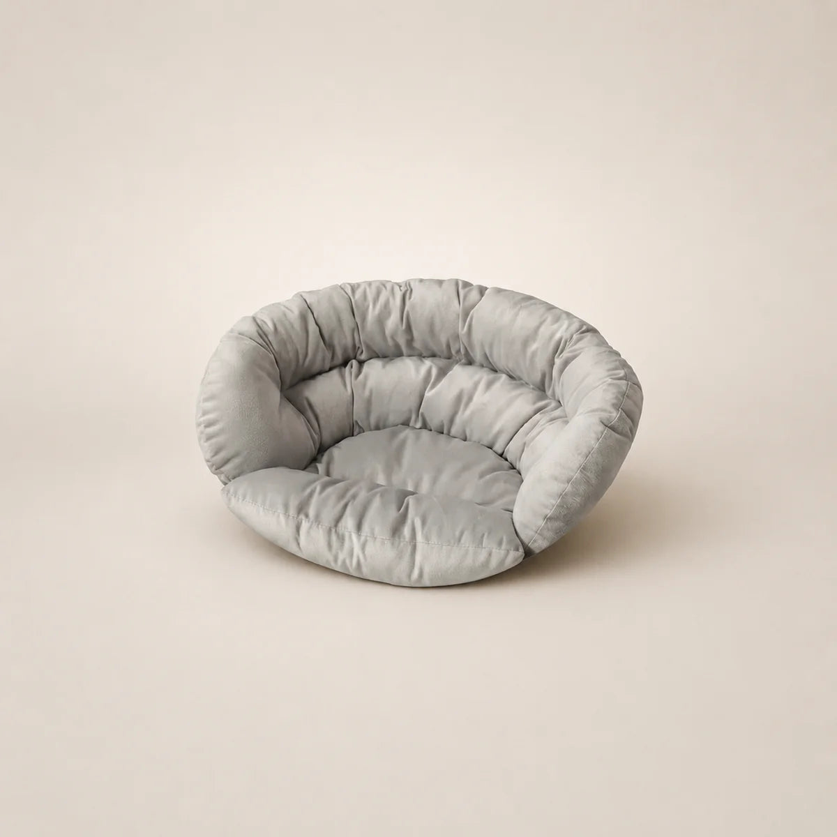 Light gray pet bed on a beige background