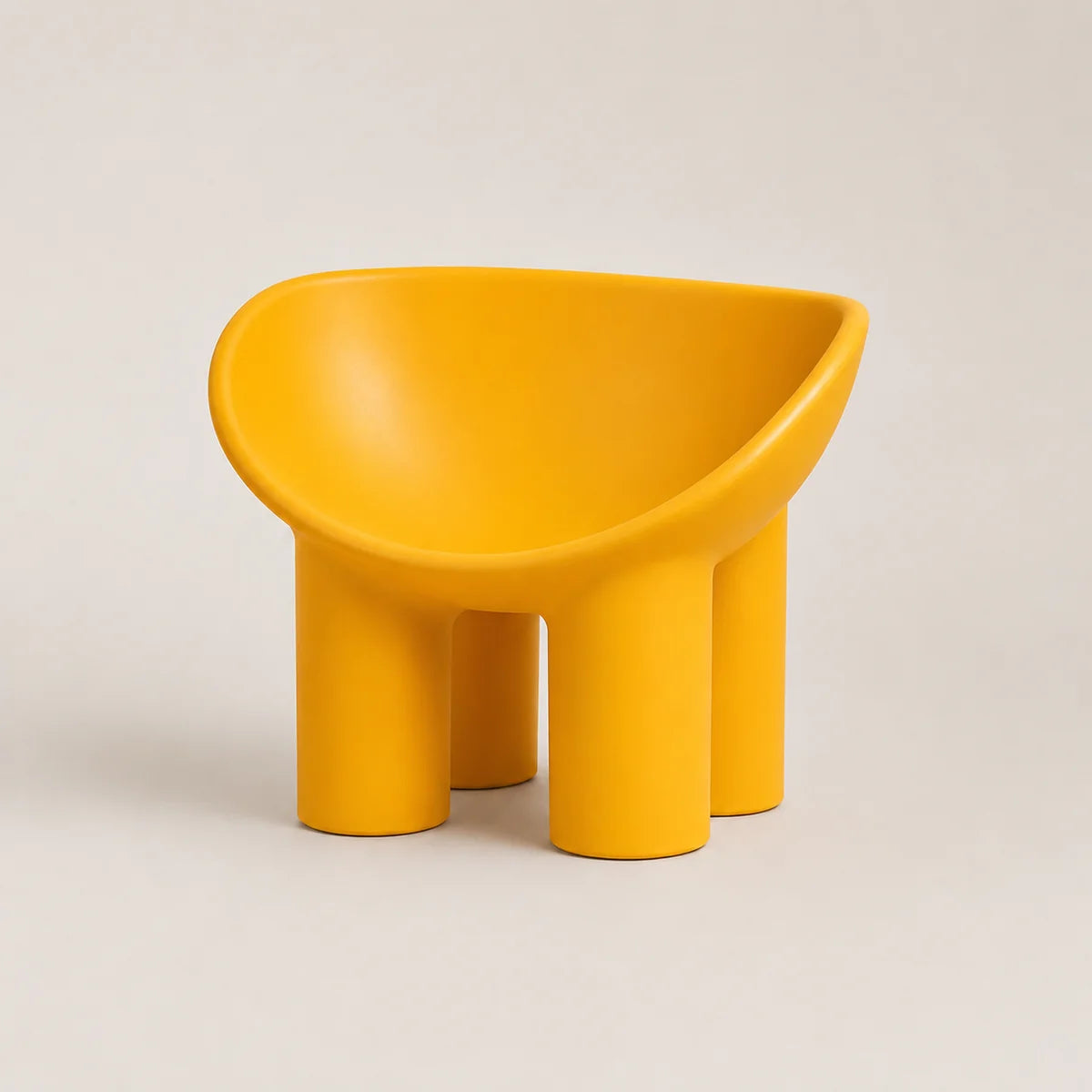 A bright yellow molded PE chair with a rounded, bowl-like seat and four cylindrical legs, photographed on a clean light beige studio background.