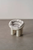 Modern plastic toddler chair with a cushion on a gray floor and white wall
