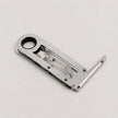A polished silver metal latch or lock mechanism with a circular hole in the top-left and a bent extension on the right, photographed on a clean light gray background.