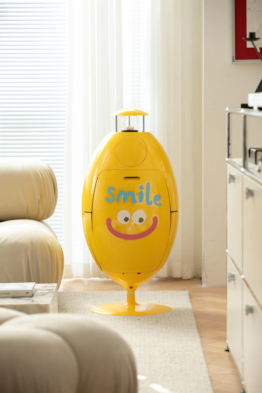 Yellow smiley face-shaped recycle bin with 'smile' text in a living room.