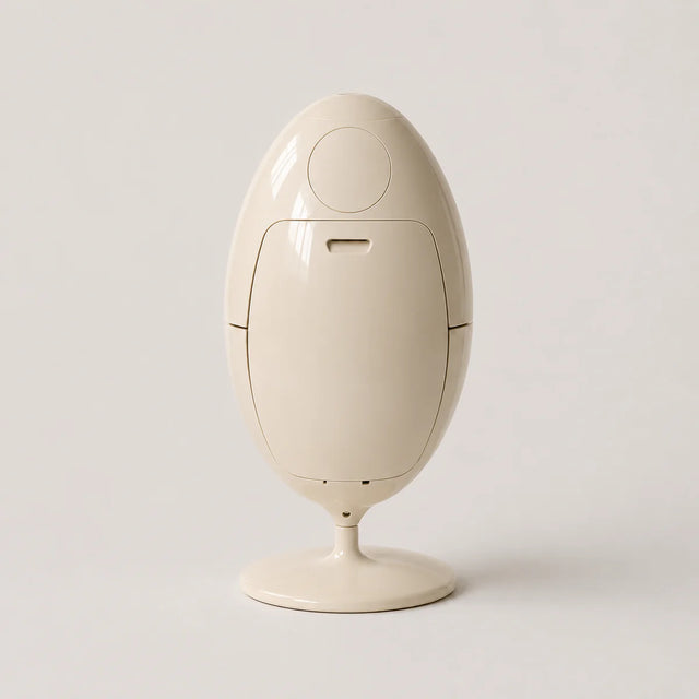 Beige abs plastic trash can shaped like an egg on a light gray background