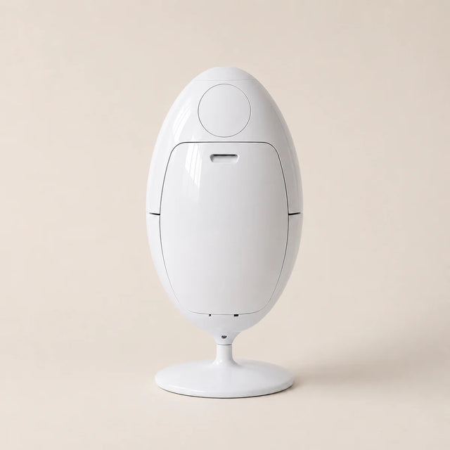 White egg-shaped trash can on a beige background