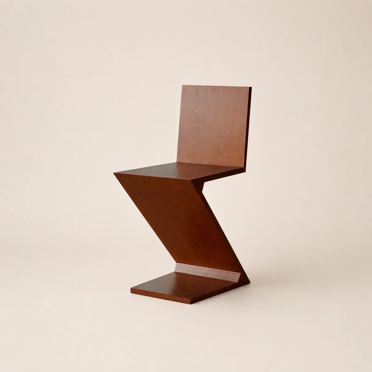 Wooden chair with a unique zigzag design on a beige background