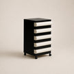 Black and white drawer unit on a beige background