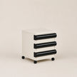 White and black three-drawer rolling cabinet on a beige background