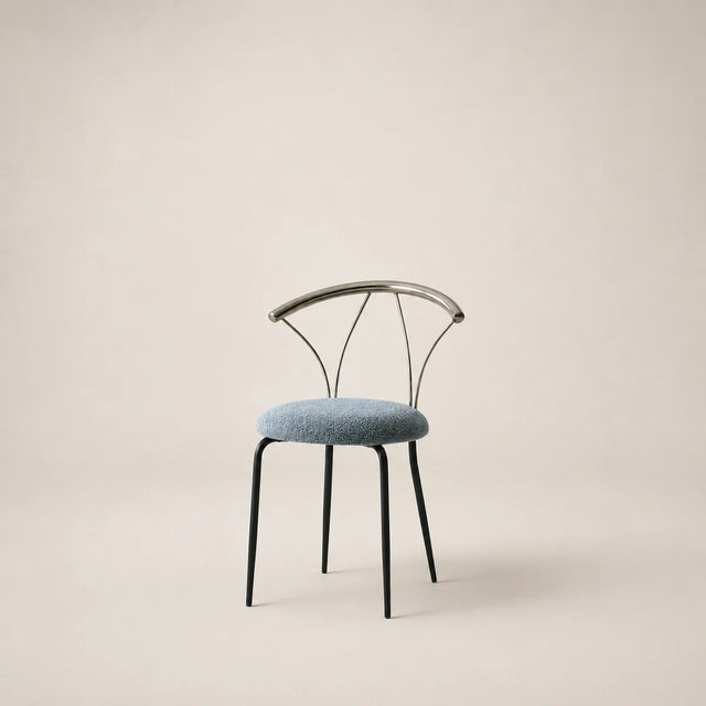 Chair with black metal frame and blue cushion on a beige background
