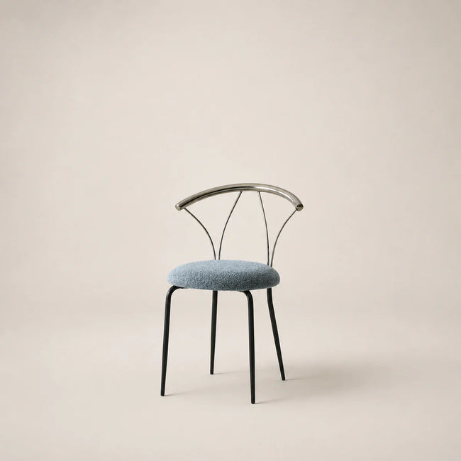 Chair with black metal frame and blue cushion on a beige background