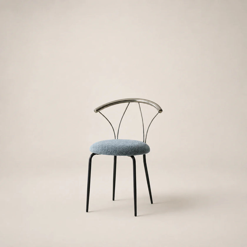 Chair with black metal frame and blue cushion on a beige background