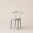 Modern chair with metal frame and upholstered seat on a beige background