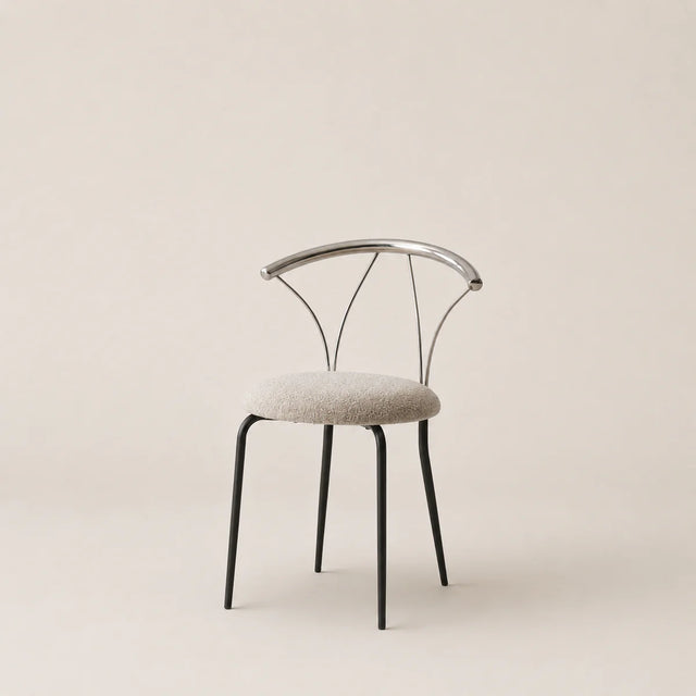 Modern chair with metal frame and upholstered seat on a beige background
