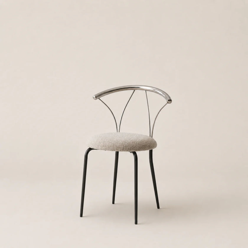 Modern chair with metal frame and upholstered seat on a beige background