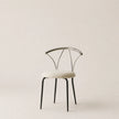 Modern chair with a white cushioned seat on a beige background