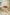 Red polka dot counter stool in a living room setting with a cart, books, and a candle.