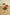 Set of three perforated stools in green, red, and black on a wooden floor.