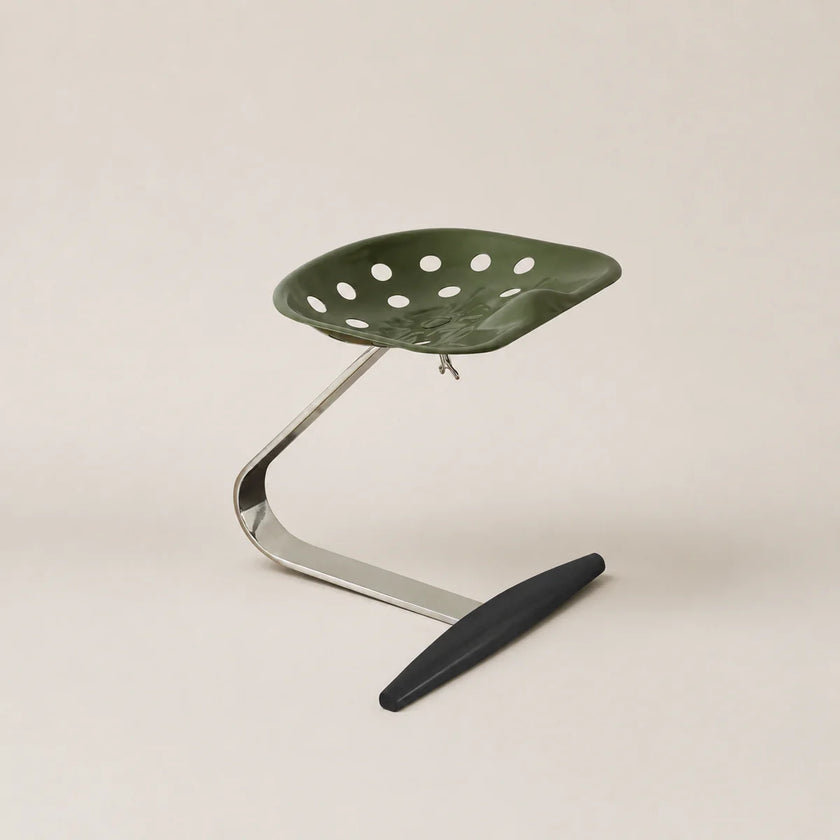 Green chair with perforated design on a beige background