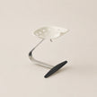 Metal stool with a black footrest on a beige background