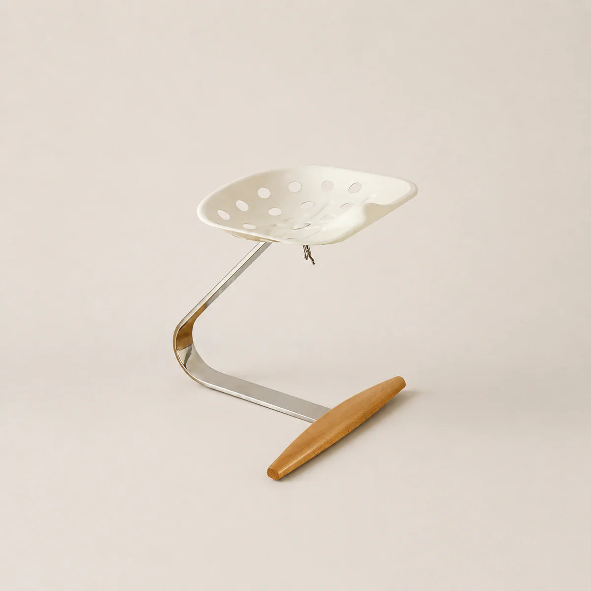 Metal stool with a wooden seat on a beige background