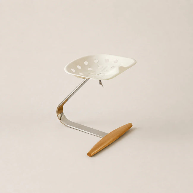 Metal stool with a wooden seat on a beige background