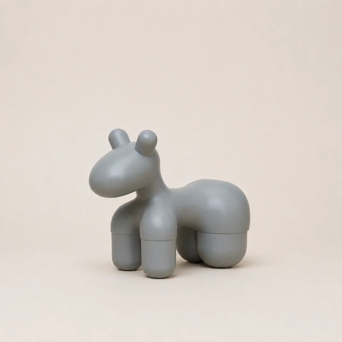 Gray horse-shaped object on a beige background