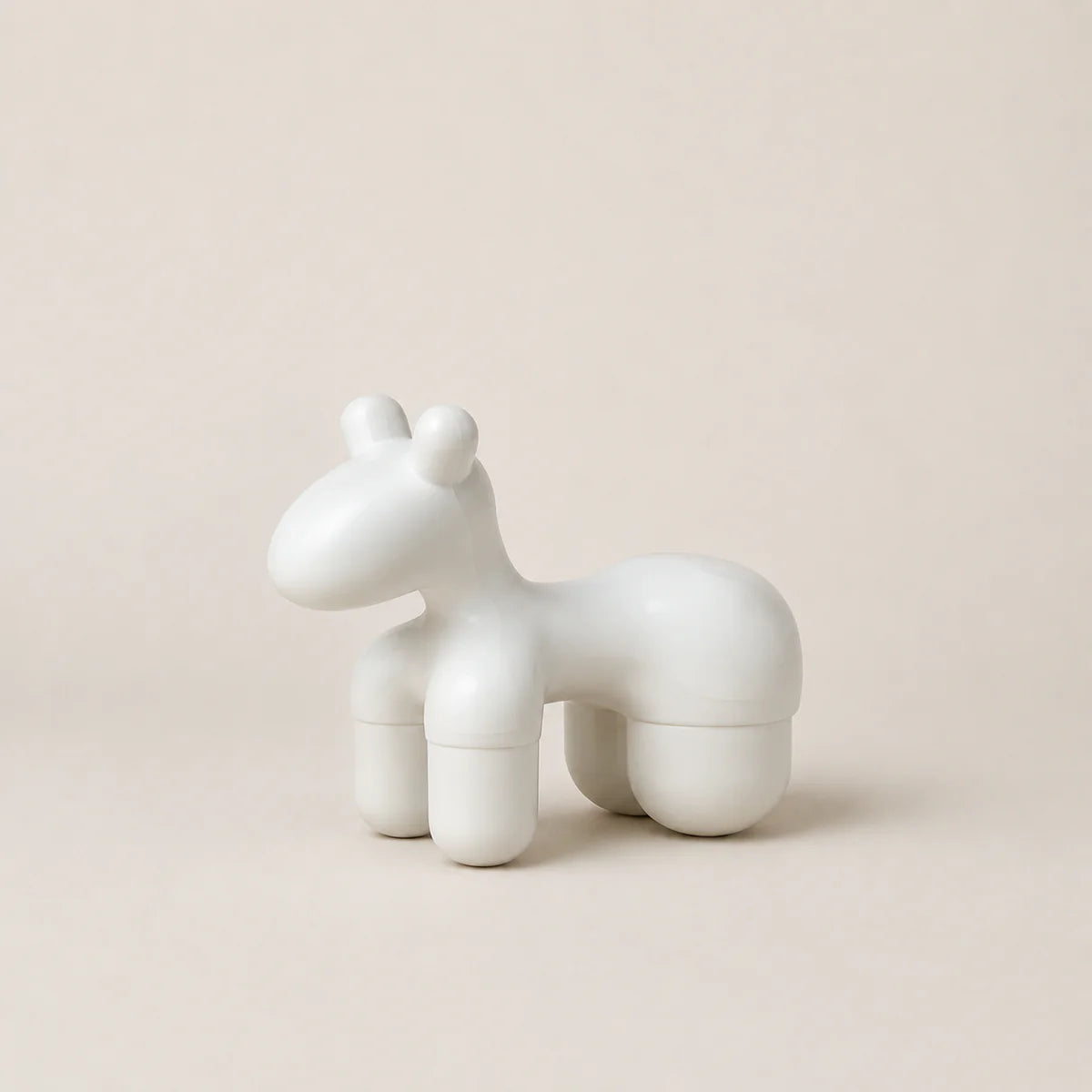 White ceramic horse sculpture on a beige background