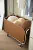 Modern brown rolling storage coat rack with wheels in a room setting