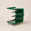 Green rolling cart with multiple shelves on a beige background