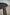 Black round bar stool with a blurred background.