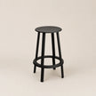Black bar stool on a beige background
