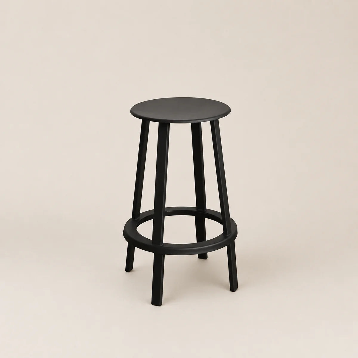 Black bar stool on a beige background