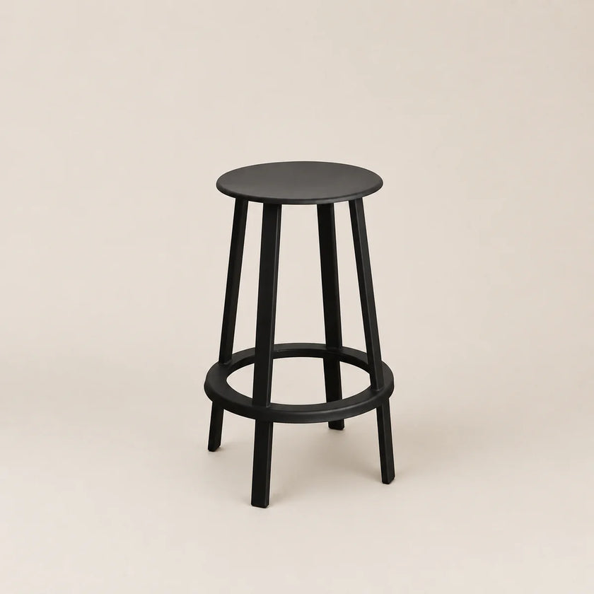 Black bar stool on a beige background