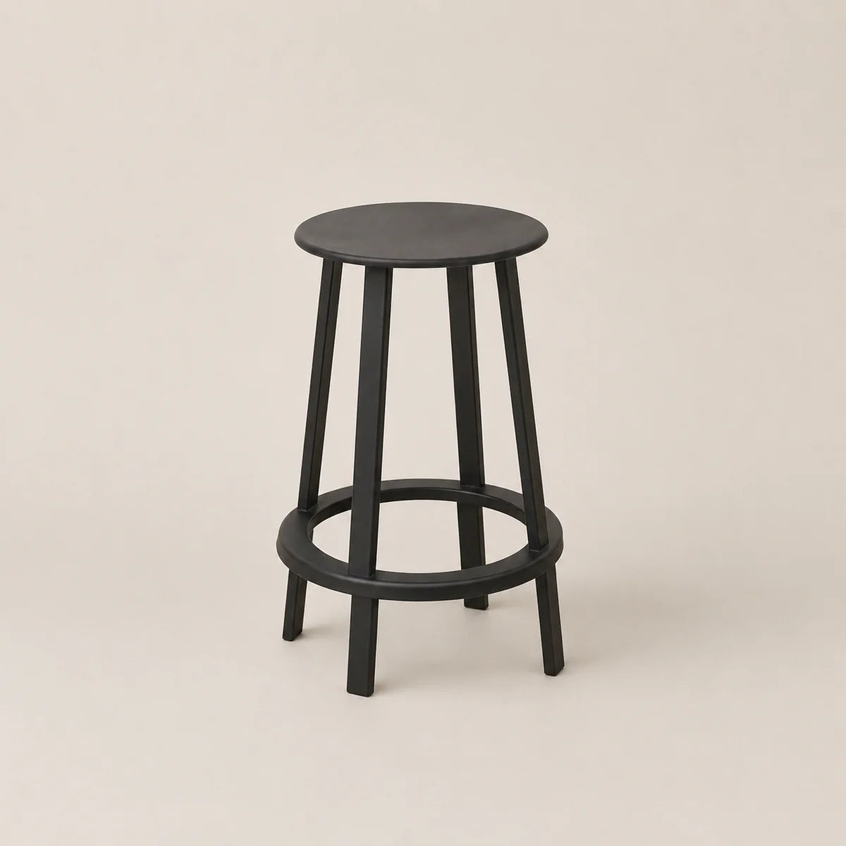 Black bar stool on a beige background