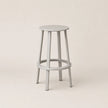 Gray bar stool on a beige background