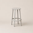 Light gray bar stool on a beige background