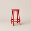 Red bar stool on a beige background