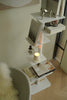 White corner storage trinket shelf with decorative items against a neutral wall