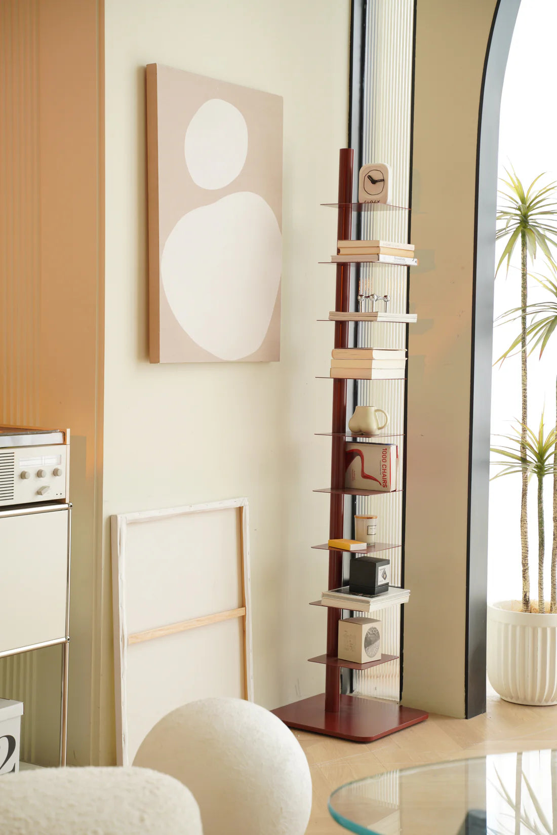 Tall metal display storage bookshelf with decorative items in a living room setting