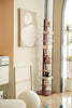 Tall metal display storage bookshelf with decorative items in a living room setting