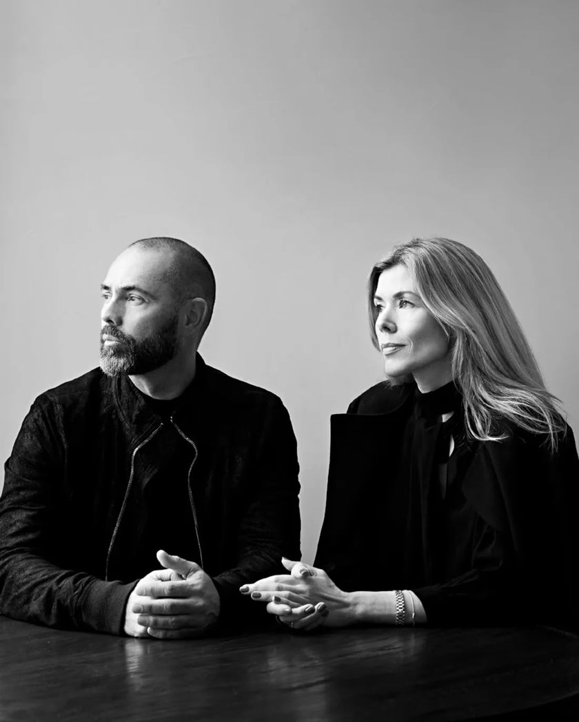 Black and white portrait of a man and woman sitting side by side.