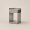 Metal side table on a beige background