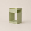 Green side table on a beige background