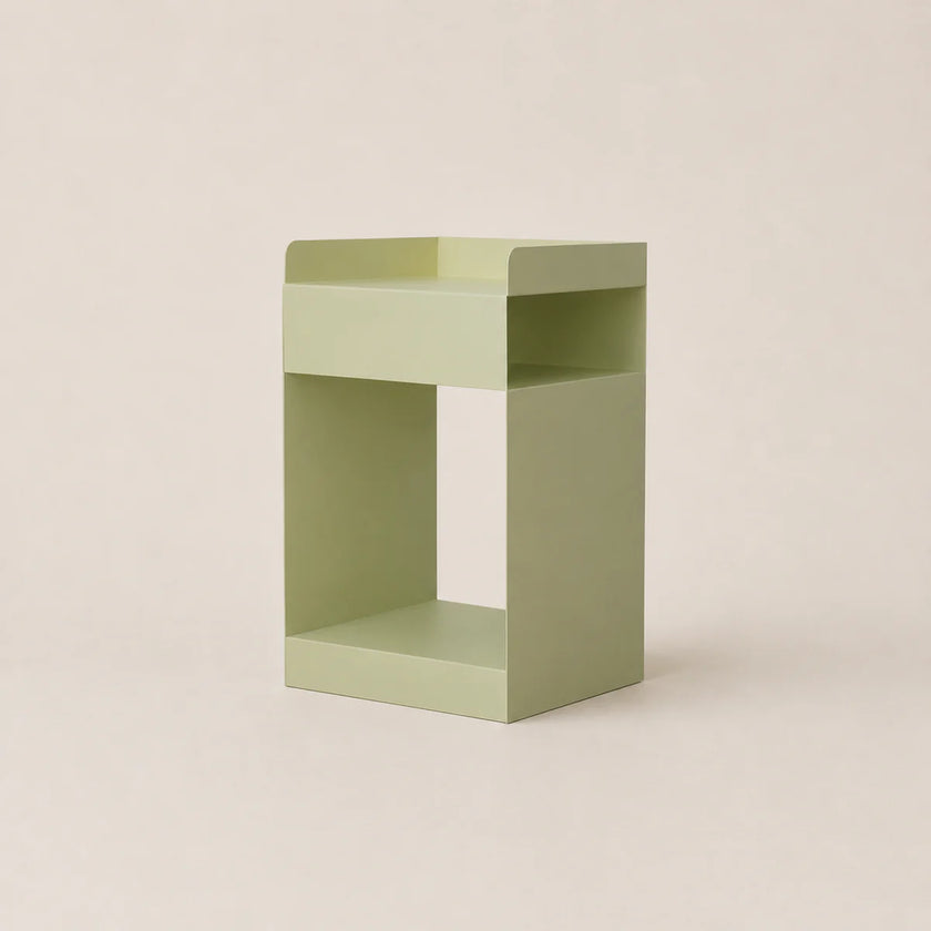 Green side table on a beige background