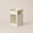 White cube-shaped shelf on a beige background