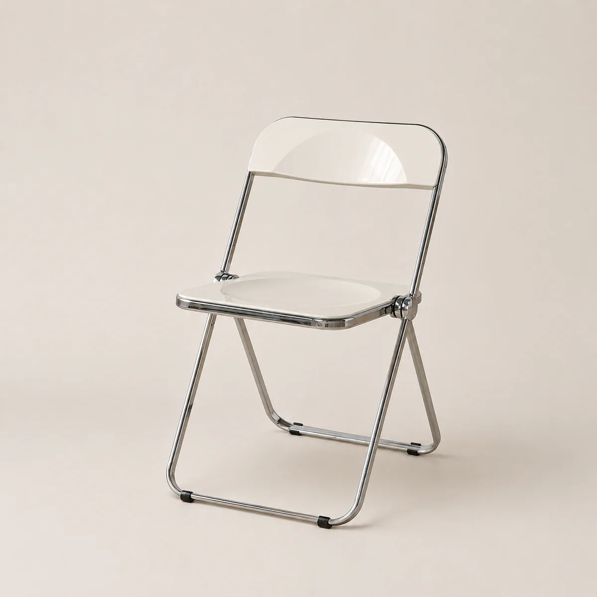 Clear plastic folding chair with metal frame on a beige background