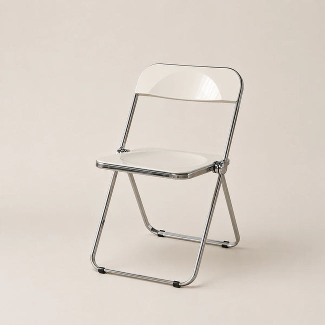 Clear plastic folding chair with metal frame on a beige background
