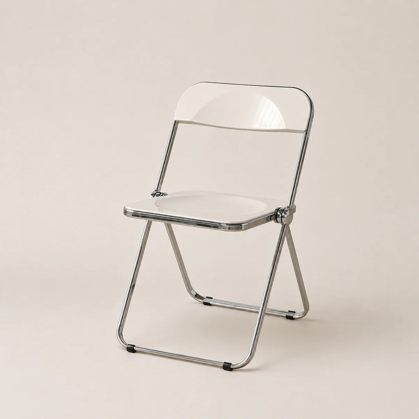 Clear plastic folding chair with metal frame on a beige background