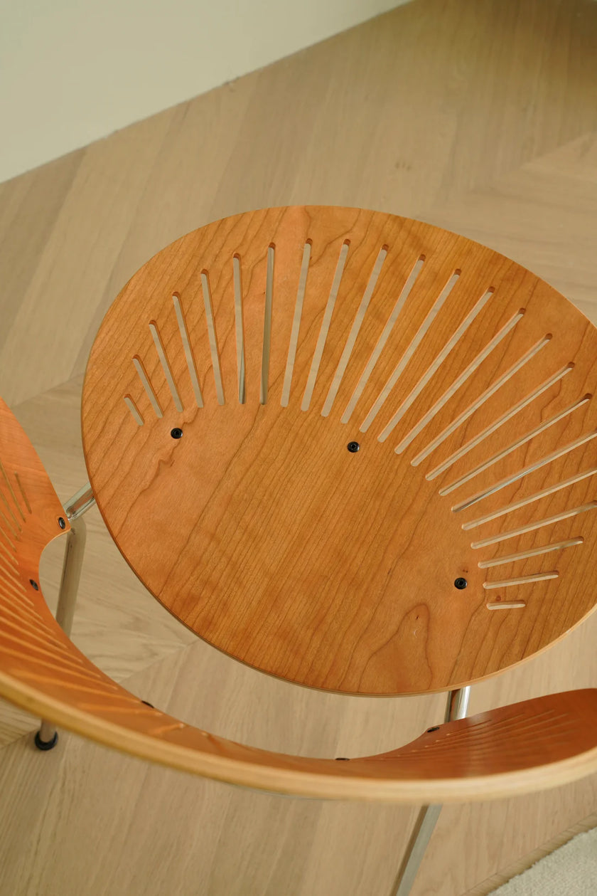 Wooden chair with a unique design on a wooden floor