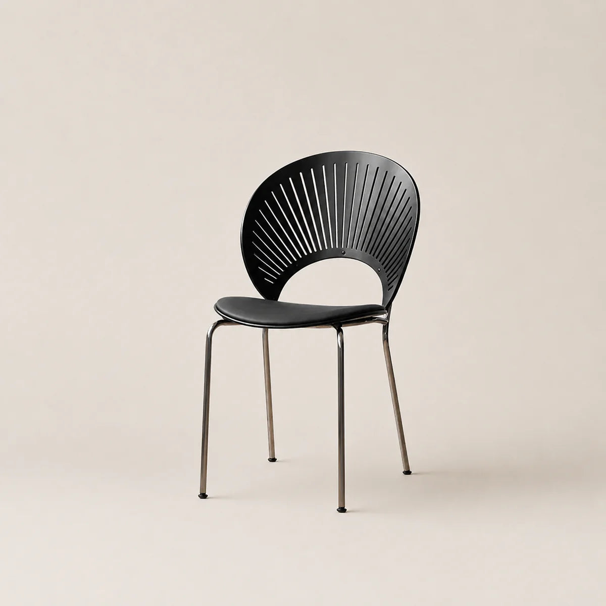 Black chair with fan-like backrest on a beige background